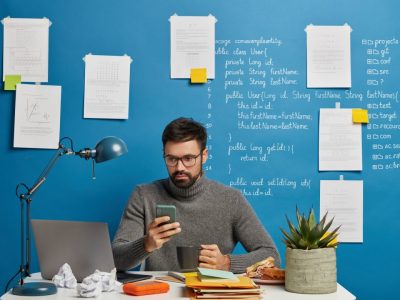 it-professional-works-on-startup-project-updates-software-and-database-on-mobile-phone-drinks-hot.jpg